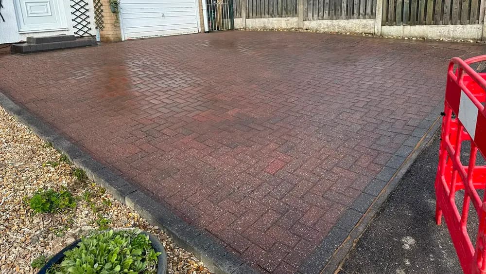 Red block paving washed back to its original colour.