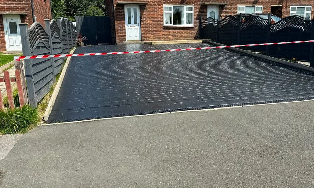 An imprinted concrete driveway after cleaning and resealing.